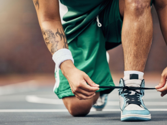 seseorang menali sepatu sebelum bermain basket